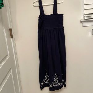 Blue dress with white vines and flowers on it